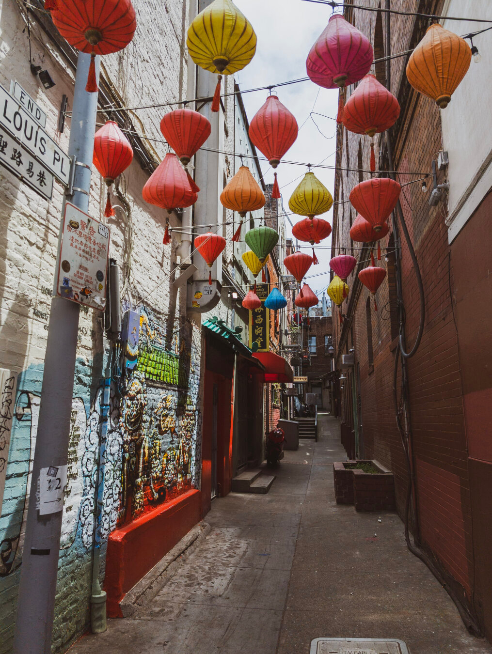 Looking down an alleyway in Chinatown with Chinese lanterns hanging on wires above